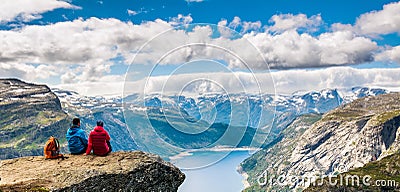 Couple sitting against amazing nature view on the way to Trolltunga. Location: Scandinavian Stock Photo