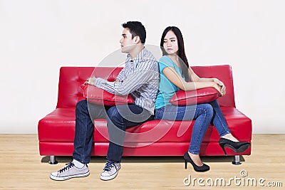 Couple sitting back to back after a fight Stock Photo