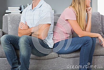 Couple sitting back to back after a fight on the sofa Stock Photo