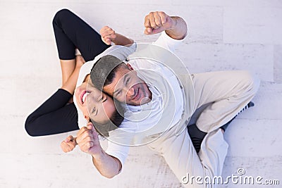 Couple sitting with back to each other on floor Stock Photo