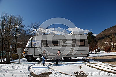 Couple Sitting Outside Motorhome Stock Photo