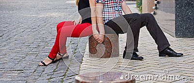 Couple sitting on the pavement Stock Photo