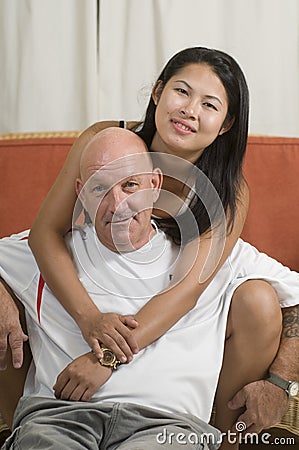 Couple sitting together and smiling Stock Photo
