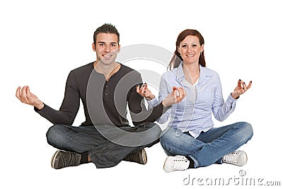 Couple sitting in yoga position Stock Photo