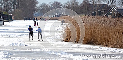 Couple skating on natural ice, Netherlands Editorial Stock Photo