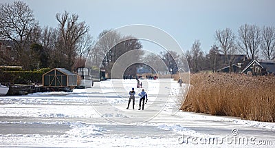 Couple skating on natural ice, Netherlands Editorial Stock Photo