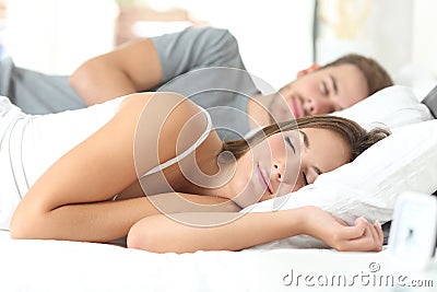 Couple sleeping in a comfortable bed Stock Photo