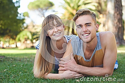 Couple, smile in portrait and relax on grass in park, love and commitment in healthy relationship with picnic outdoor Stock Photo