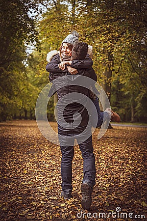 Couple spin hugging in happiness after she says yes to proposing marriage.. Stock Photo