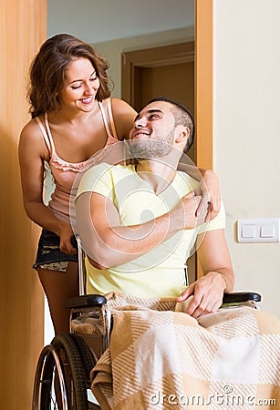 Couple with spouse in wheelchair near door Stock Photo