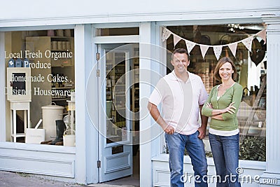 Couple standing in front of organic food store Stock Photo