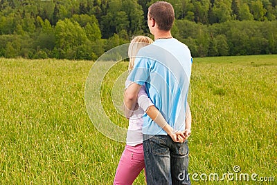 Couple standing and hugging in nature Stock Photo