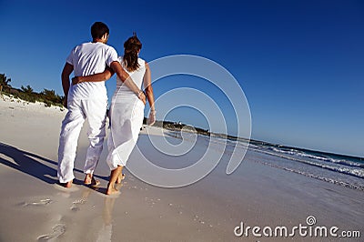 Couple strolling on beach Stock Photo