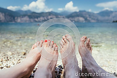 Couple in the summer holidays: Feet in the crystal clear water Stock Photo