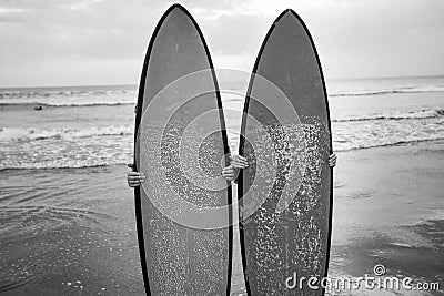 Couple of surfers behind the surfboards Stock Photo