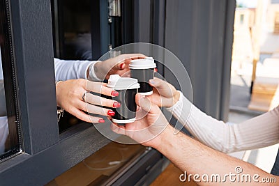 Couple takes takeaway coffee. Break and go outside. Outdoor date Stock Photo