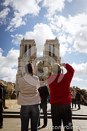 Couple taking pictures of Notre-Dame Editorial Stock Photo