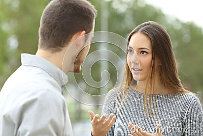 Couple talking outdoors in a park Stock Photo