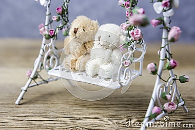 Couple teddy bear on swing Stock Photo