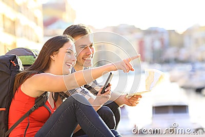 Couple of teen tourists searching location Stock Photo