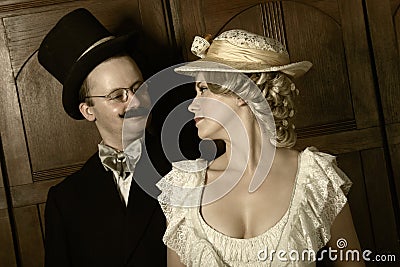 Couple in 19th century garment with woman in dominant role Stock Photo