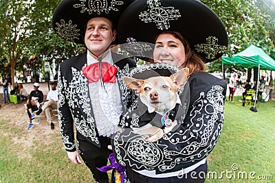 Couple And Their Chihuahua Wear Mariachi Costumes At Doggy Con Editorial Stock Photo