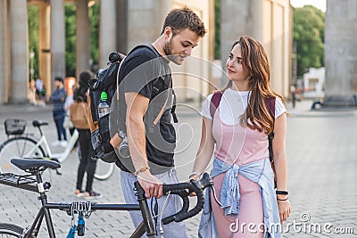 couple of tourists with backpacks and bicycle at Pariser Platz Stock Photo