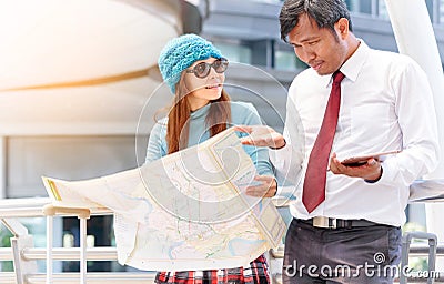 Couple of tourists consulting a city guide searching locations i Stock Photo