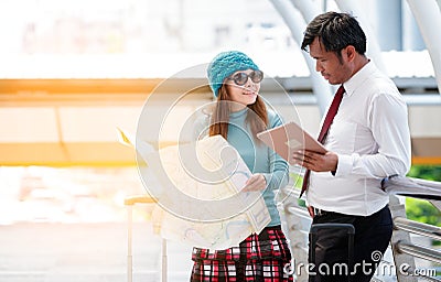 Couple of tourists consulting a city guide searching locations i Stock Photo