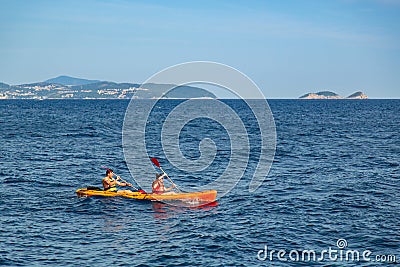 A couple of tourists kayaking around the old port of Dubrovnik in Croatia Editorial Stock Photo