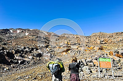 Couple tourists planning to trail at mountain Editorial Stock Photo