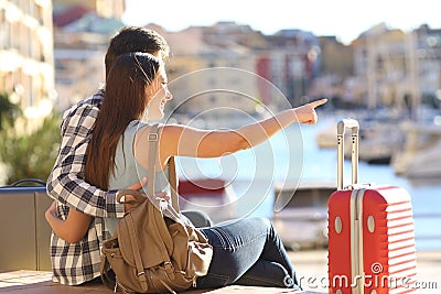 Couple of tourists pointing vacations destination Stock Photo