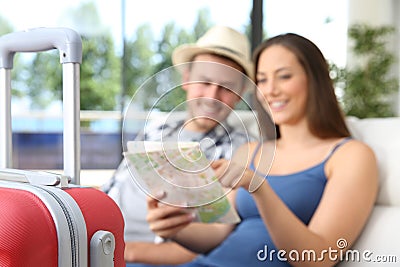 Couple of tourists searching location in a map Stock Photo