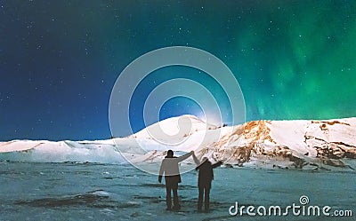 Couple Travelers enjoying Northern lights Stock Photo