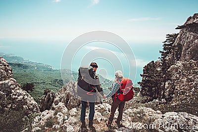 Couple travelers Man and Woman holding hands enjoying mountains aerial view Stock Photo