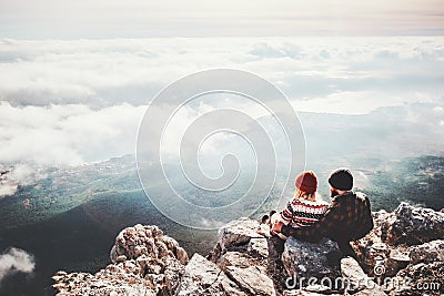 Couple travelers Man and Woman sitting on cliff Stock Photo