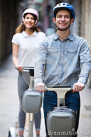 Couple traveling by segways Stock Photo