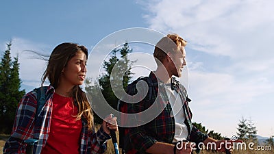 Couple trekking mountains at vacation. Man and woman talking during hiking Stock Photo