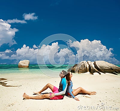 Couple at tropical beach wearing rash guard Stock Photo