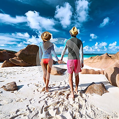 Couple at tropical beach wearing rash guard Stock Photo