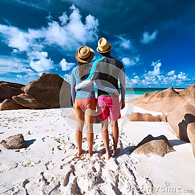 Couple at tropical beach wearing rash guard Stock Photo