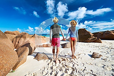 Couple at tropical beach wearing rash guard Stock Photo