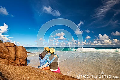 Couple at tropical beach wearing rash guard Stock Photo