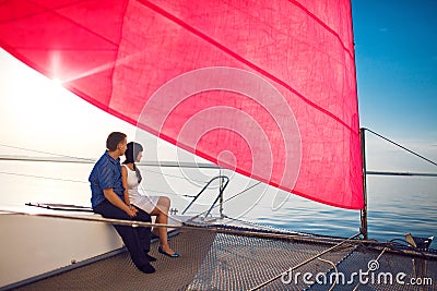 Couple under the red sail Stock Photo