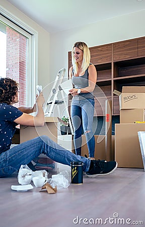 Couple unpacking moving boxes Stock Photo