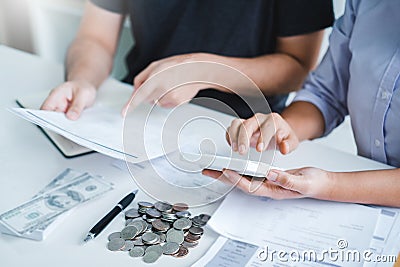 Couple using calculator Accounting Calculating Cost Economic bills with money stack step growing growth saving money in home , Stock Photo