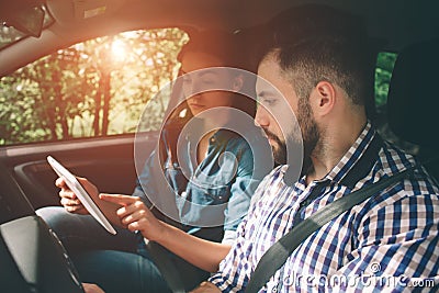 Couple using gps on tablet compter to navigate in car on holiday Stock Photo