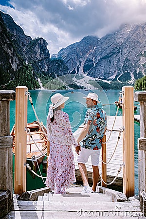 Couple visit the famous lake Lago Di Braies Italy, Pragser Wildsee in South Tyrol, Beautiful lake in the italian alps Stock Photo
