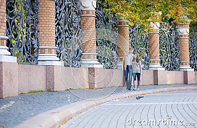 Couple walking by the grill of Mikhailovsky garden Stock Photo