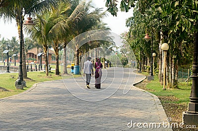 Couple walking on a park. Rear view. Public Garden footpath in Eco Tourism Park Kolkata, New Town, West Bengal India South Asia Editorial Stock Photo